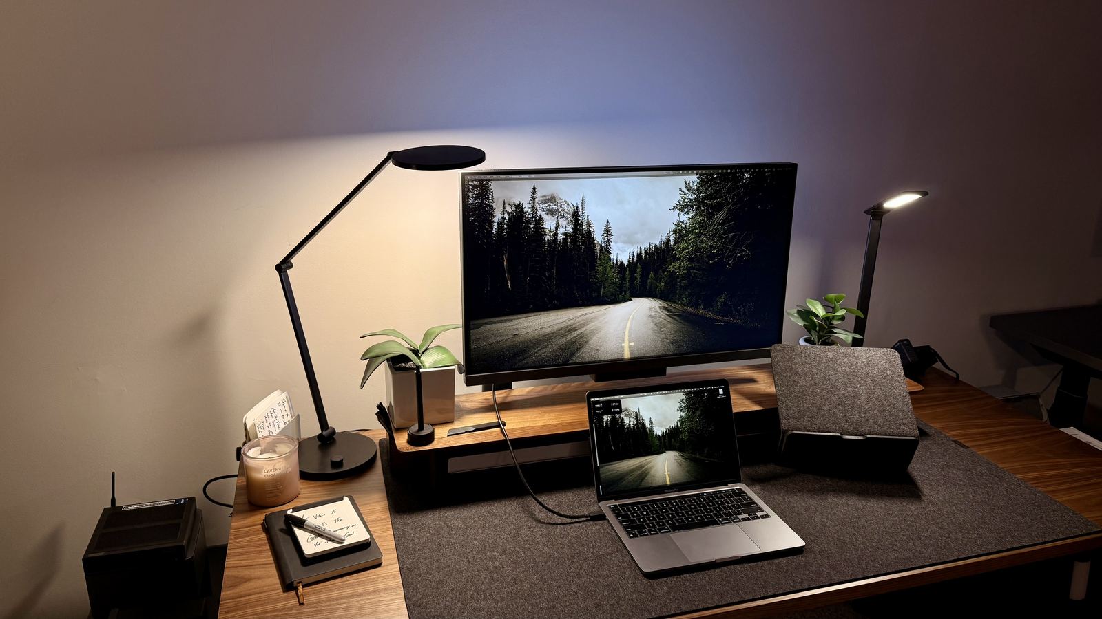 Developer coding at a laptop in a dark room with glowing screen