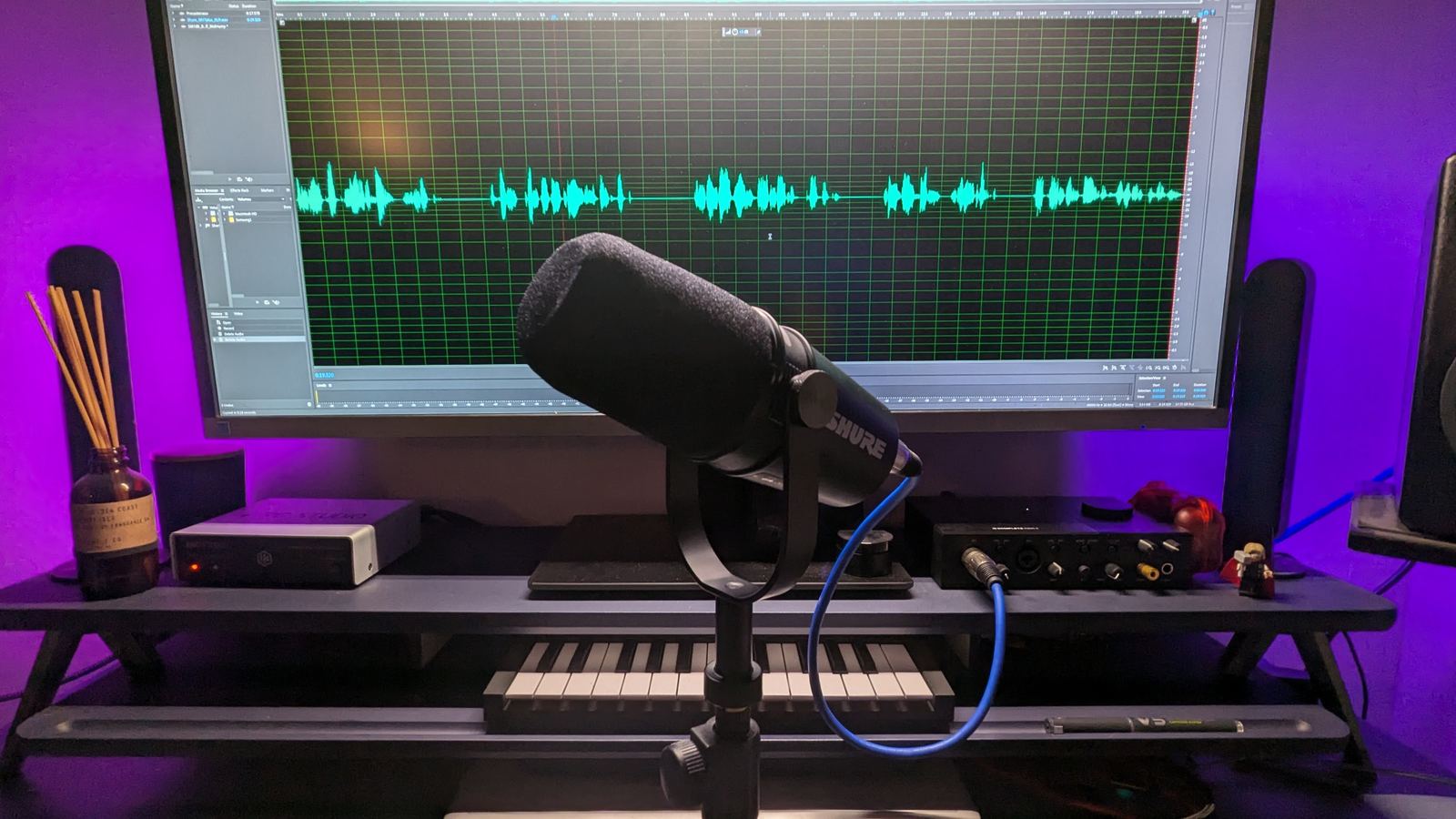 Home music studio setup with audio interface, laptop and mixer on a wooden desk